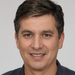 Joyful white adult male with short  brown hair and brown eyes