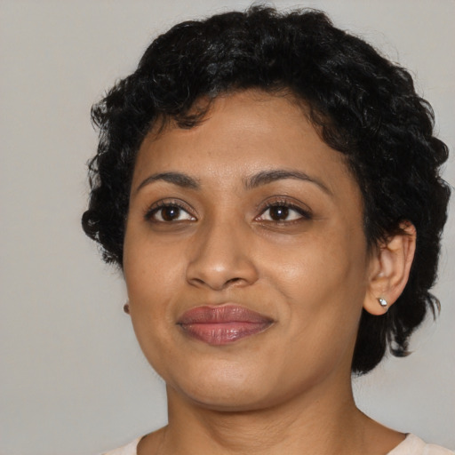 Joyful black young-adult female with medium  black hair and brown eyes
