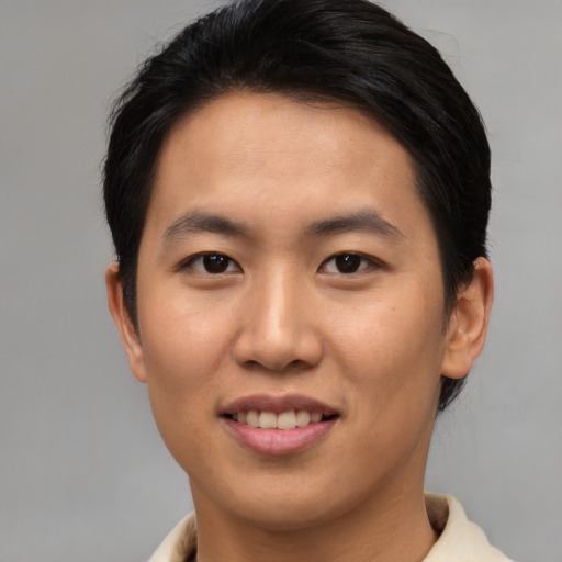 Joyful asian young-adult male with short  brown hair and brown eyes
