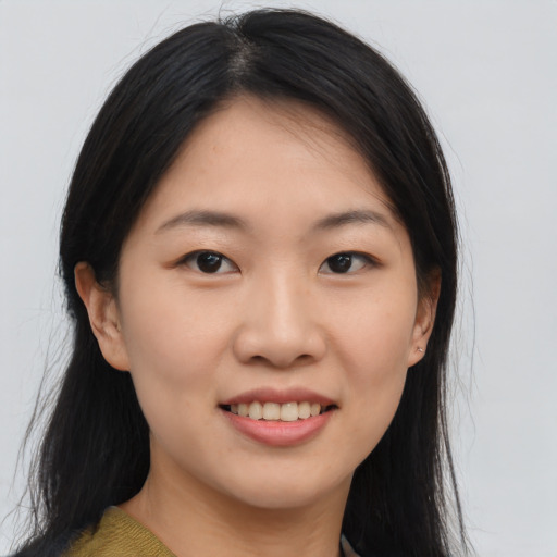 Joyful asian young-adult female with long  brown hair and brown eyes