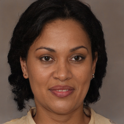 Joyful latino adult female with medium  brown hair and brown eyes