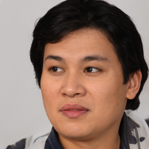 Joyful asian young-adult female with medium  black hair and brown eyes