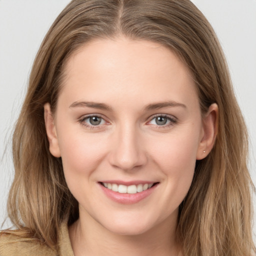 Joyful white young-adult female with long  brown hair and grey eyes