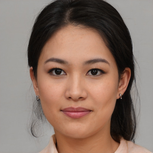 Joyful asian young-adult female with medium  brown hair and brown eyes
