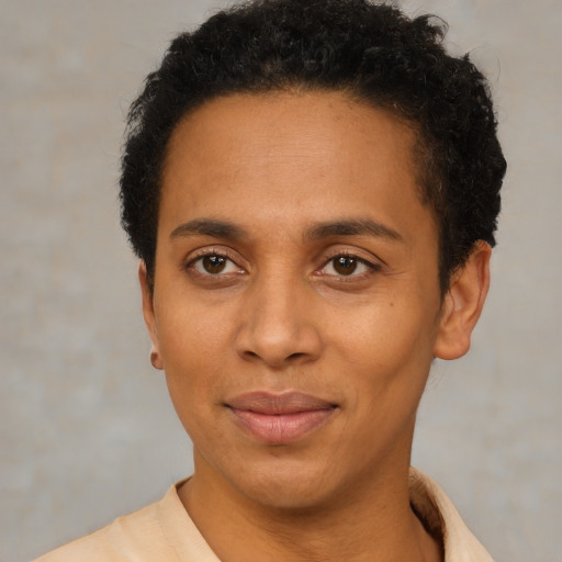 Joyful black adult female with short  brown hair and brown eyes