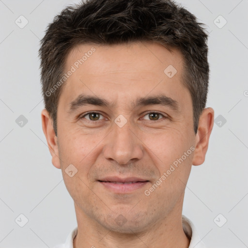 Joyful white adult male with short  brown hair and brown eyes