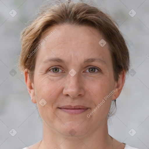 Joyful white adult female with short  brown hair and grey eyes