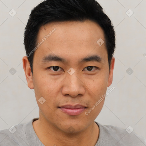 Joyful asian young-adult male with short  black hair and brown eyes