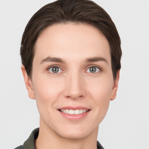 Joyful white young-adult female with short  brown hair and grey eyes