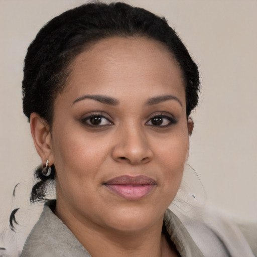 Joyful black young-adult female with medium  brown hair and brown eyes