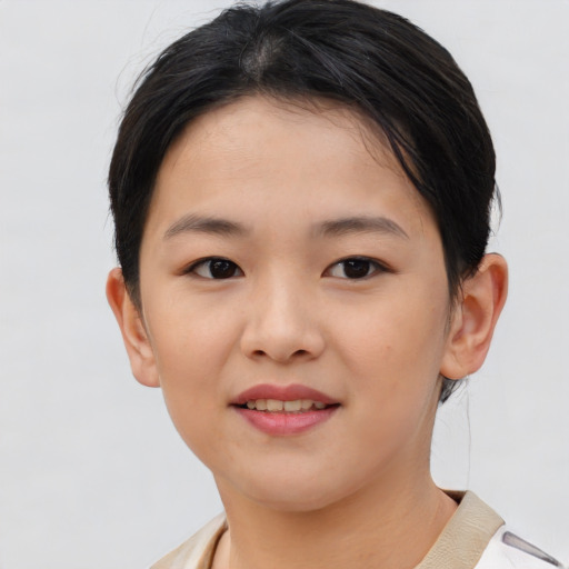 Joyful asian child female with short  brown hair and brown eyes