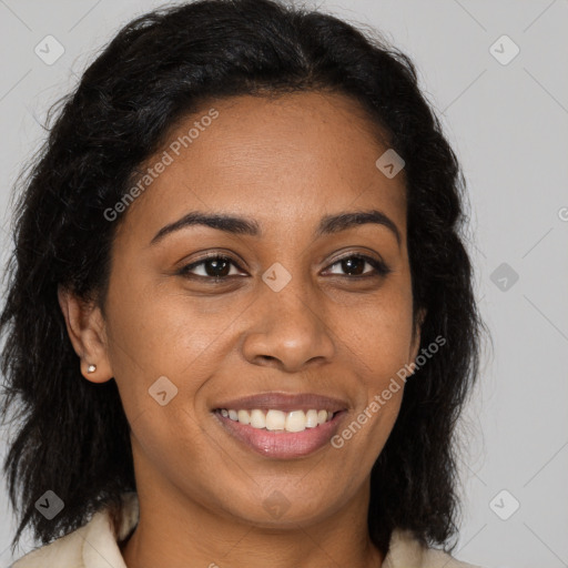 Joyful black young-adult female with long  brown hair and brown eyes