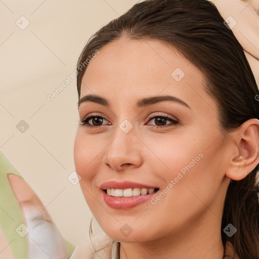 Joyful white young-adult female with long  brown hair and brown eyes