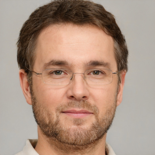 Joyful white adult male with short  brown hair and green eyes