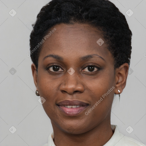 Joyful black young-adult female with short  black hair and brown eyes