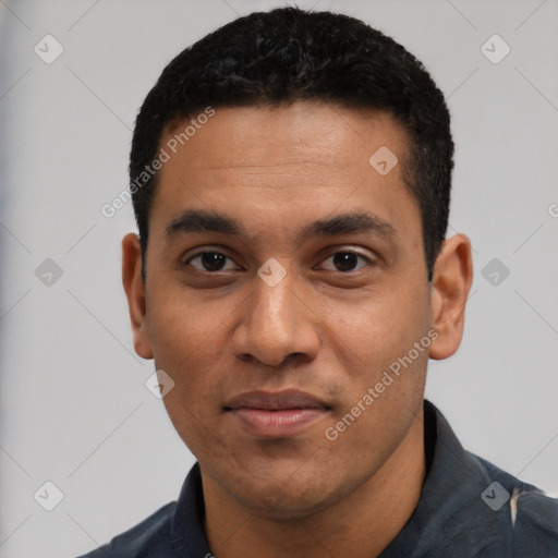 Joyful latino young-adult male with short  black hair and brown eyes