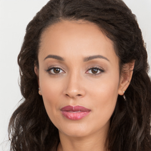 Joyful white young-adult female with long  brown hair and brown eyes