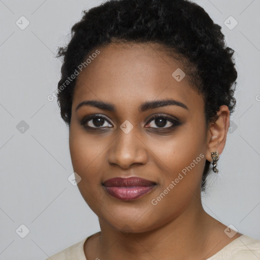 Joyful black young-adult female with short  black hair and brown eyes