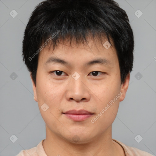 Joyful asian young-adult male with short  brown hair and brown eyes