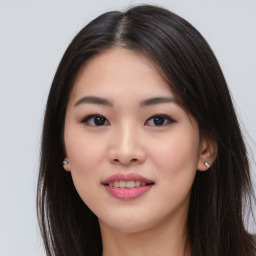 Joyful asian young-adult female with long  brown hair and brown eyes