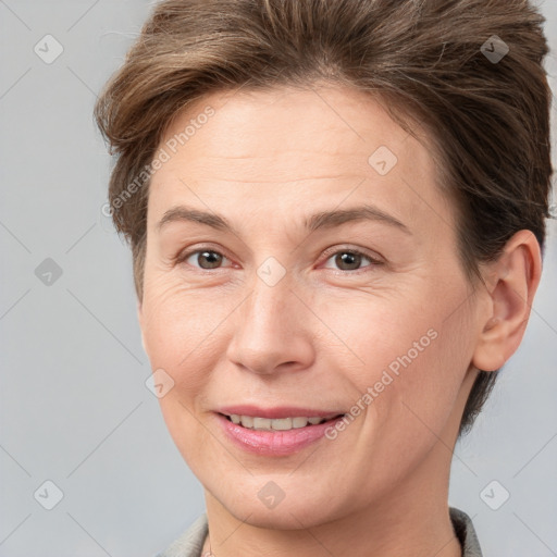 Joyful white adult female with short  brown hair and brown eyes