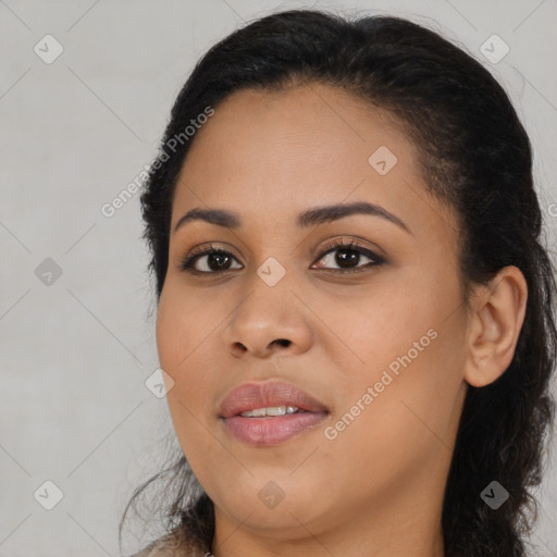 Joyful black young-adult female with long  black hair and brown eyes