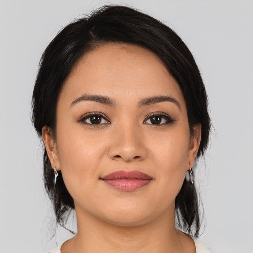 Joyful latino young-adult female with medium  black hair and brown eyes