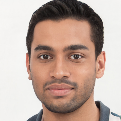 Joyful white young-adult male with short  black hair and brown eyes