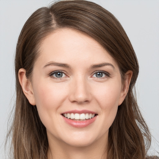 Joyful white young-adult female with long  brown hair and grey eyes