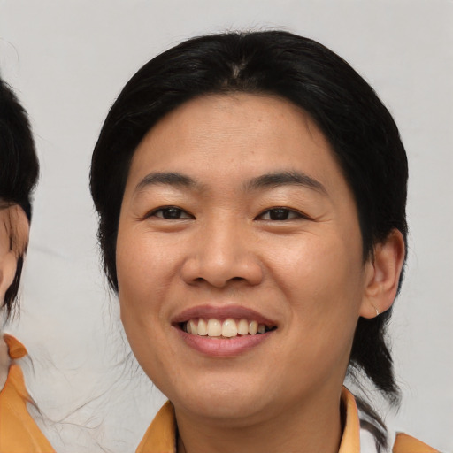 Joyful asian young-adult female with medium  black hair and brown eyes