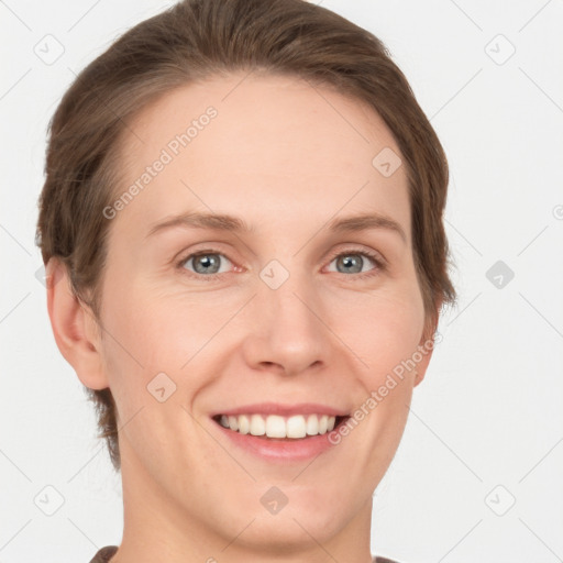 Joyful white young-adult female with short  brown hair and grey eyes