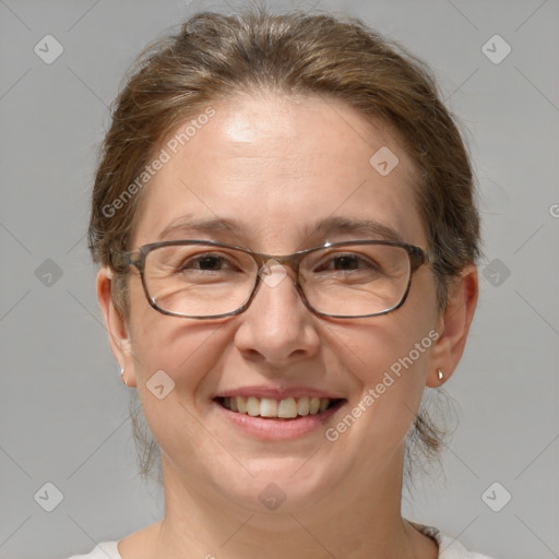 Joyful white adult female with medium  brown hair and brown eyes