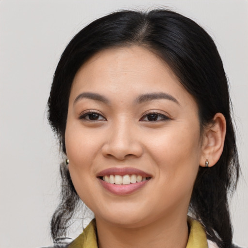 Joyful asian young-adult female with medium  black hair and brown eyes