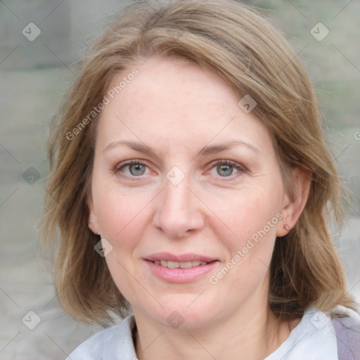 Joyful white adult female with medium  brown hair and blue eyes