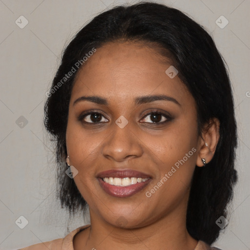 Joyful black young-adult female with medium  black hair and brown eyes