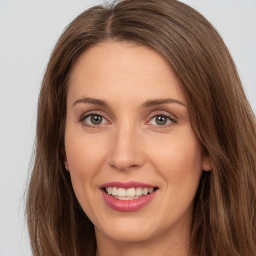 Joyful white young-adult female with long  brown hair and brown eyes