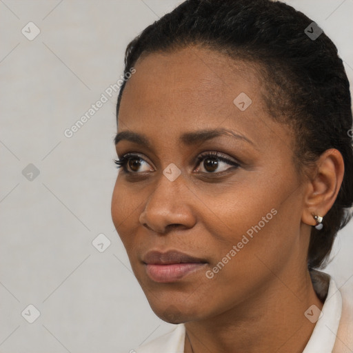 Joyful black young-adult female with short  black hair and brown eyes