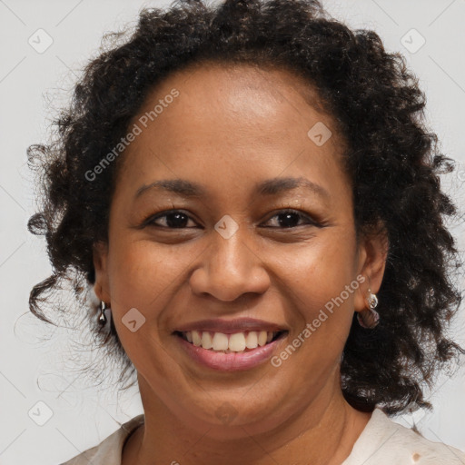 Joyful black adult female with medium  brown hair and brown eyes