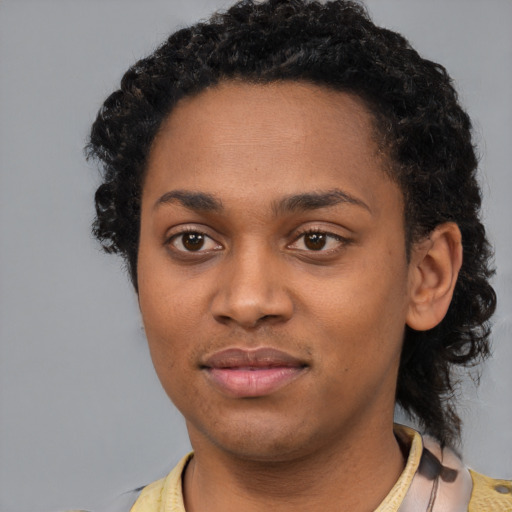 Joyful black young-adult female with short  black hair and brown eyes