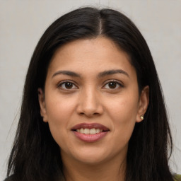 Joyful latino young-adult female with long  brown hair and brown eyes