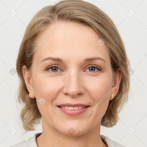 Joyful white adult female with medium  brown hair and grey eyes