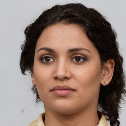 Joyful latino young-adult female with medium  brown hair and brown eyes