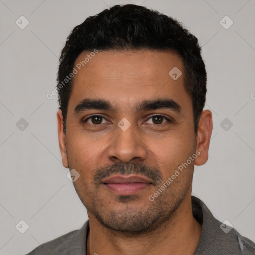 Joyful latino young-adult male with short  black hair and brown eyes