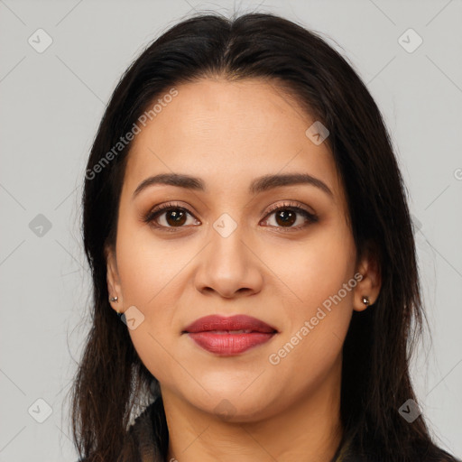 Joyful latino young-adult female with long  brown hair and brown eyes