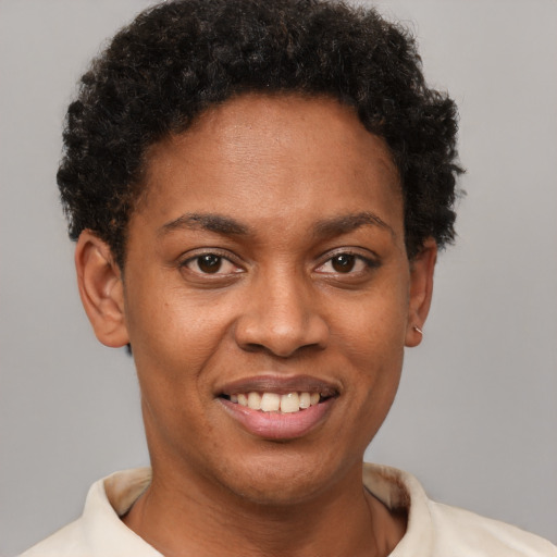 Joyful black young-adult female with short  brown hair and brown eyes