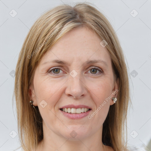 Joyful white adult female with medium  brown hair and grey eyes