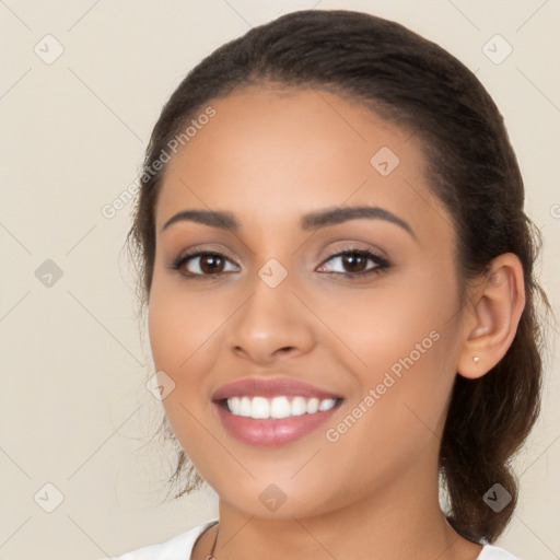 Joyful latino young-adult female with medium  brown hair and brown eyes