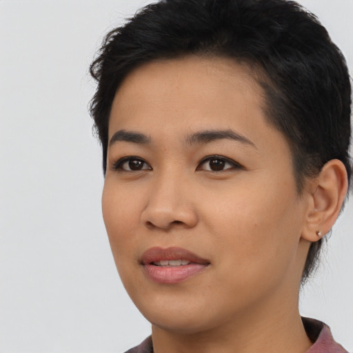 Joyful asian young-adult female with short  black hair and brown eyes