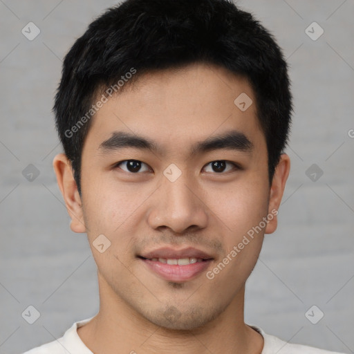 Joyful asian young-adult male with short  black hair and brown eyes