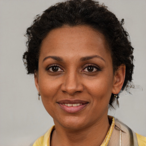 Joyful latino adult female with short  brown hair and brown eyes